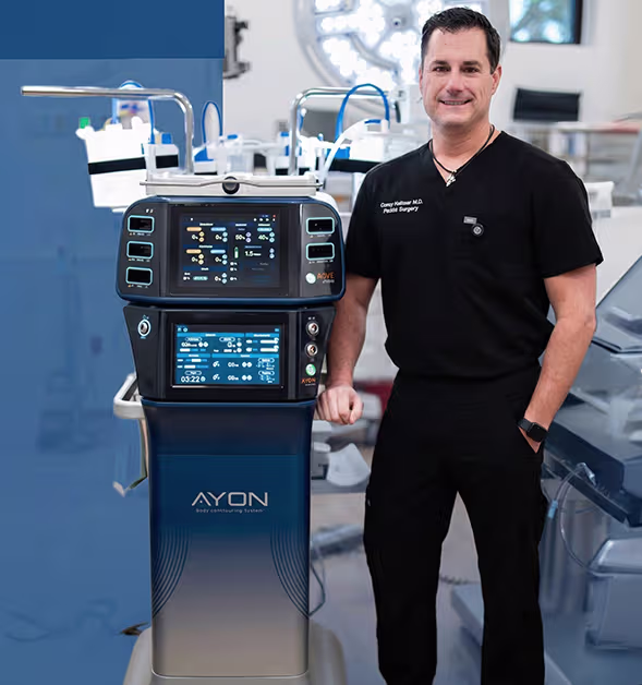 Plastic surgeon standing beside the AYON body contouring system used for liposuction and skin tightening procedures