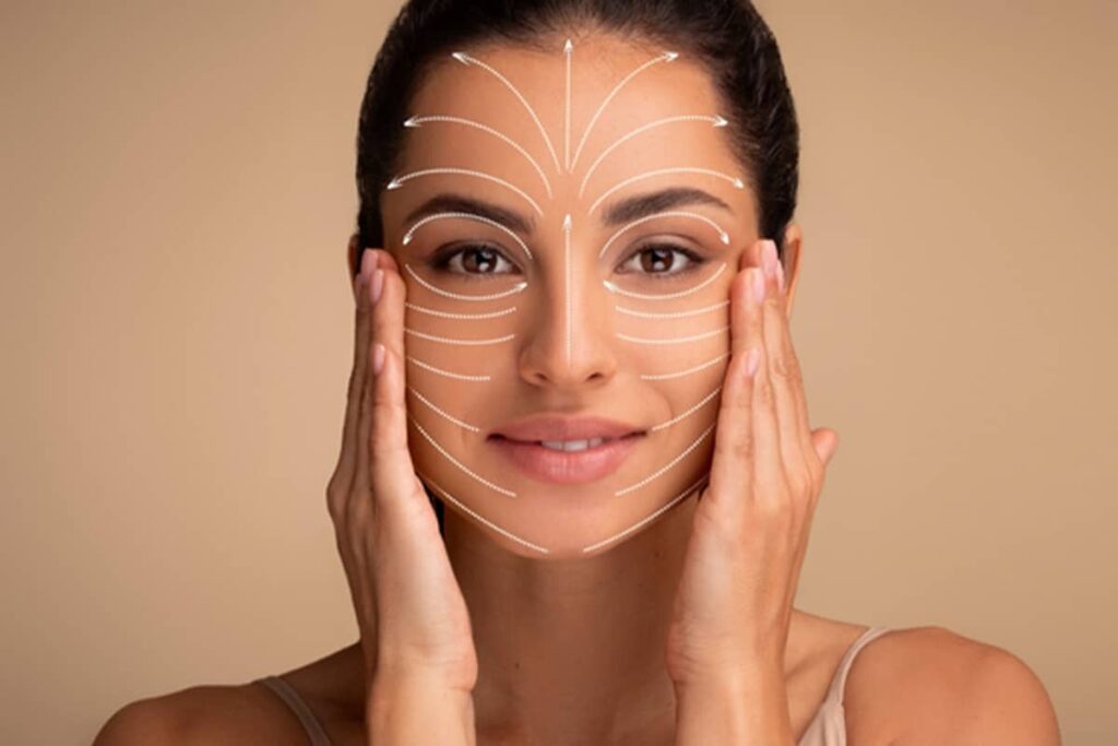 A close-up of a woman's face with white dashed arrows and lines overlaid to show the direction of lift and tightening during surgery.