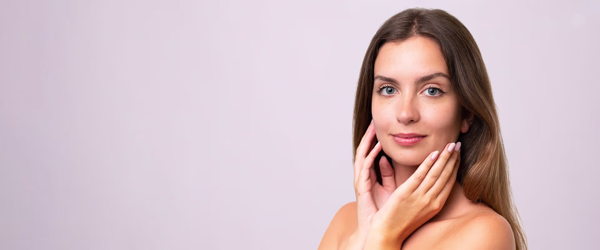 Woman touching smooth facial skin, representing PRP with microneedling for skin rejuvenation in Naples, FL.